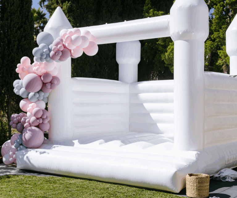 Luxury white bounce house rental setup for elegant backyard party in Orange County