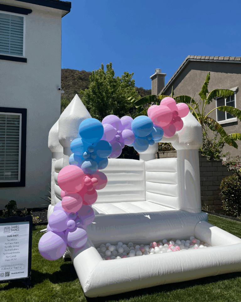 Toddler playing in a mini jumper rental set up in a small Riverside backyard